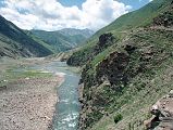 10 Narrow Scary Road Above Kunhar River Between Lake Lulusar And Naran In Kaghan Valley This road above the Kunhar River is very narrow and slants downward to the edge. My driver Ilys hugs the inside ... a little too close. I hear a pop and a loud whoosh as the air rushes out of the back tire. A sharp rock made a seven cm gash in the tire. Ilys and Iqbal change the tire in just 10 minutes. And we're off again on the scariest road in Pakistan.